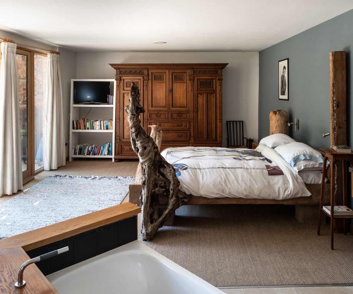 A bed with a rustic wooden frame and a sink