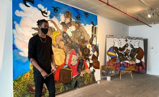 Artist Jameson Green in his Bronx studio with paintings, including Neighborhood Games Pt.2