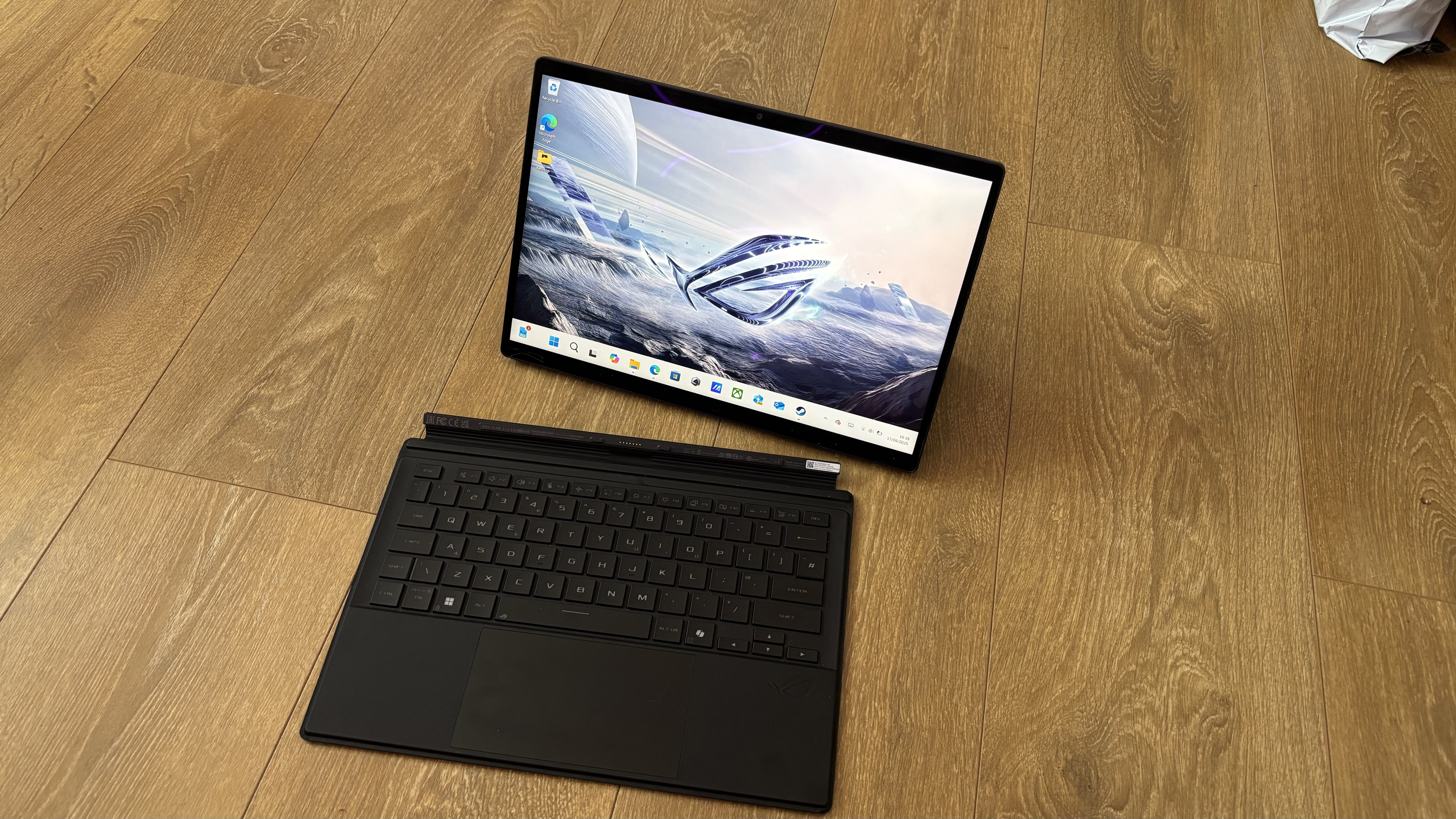 Asus ROG Flow Z13 gaming tablet on wooden surface