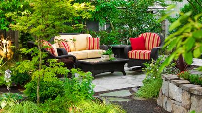 An outdoor seating area surrounded by greenery