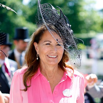 Princess Kate's mom Carole Middleton wears a bright pink dress with a black hat