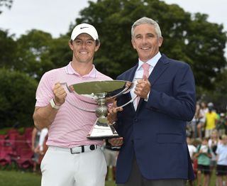 McIlroy of Northern Ireland and PGA TOUR Commissioner Jay Monahan pose with the FedExCup trophy after the TOUR Championship, the final event of the FedExCup Playoffs, at East Lake Golf Club on August 25, 2019