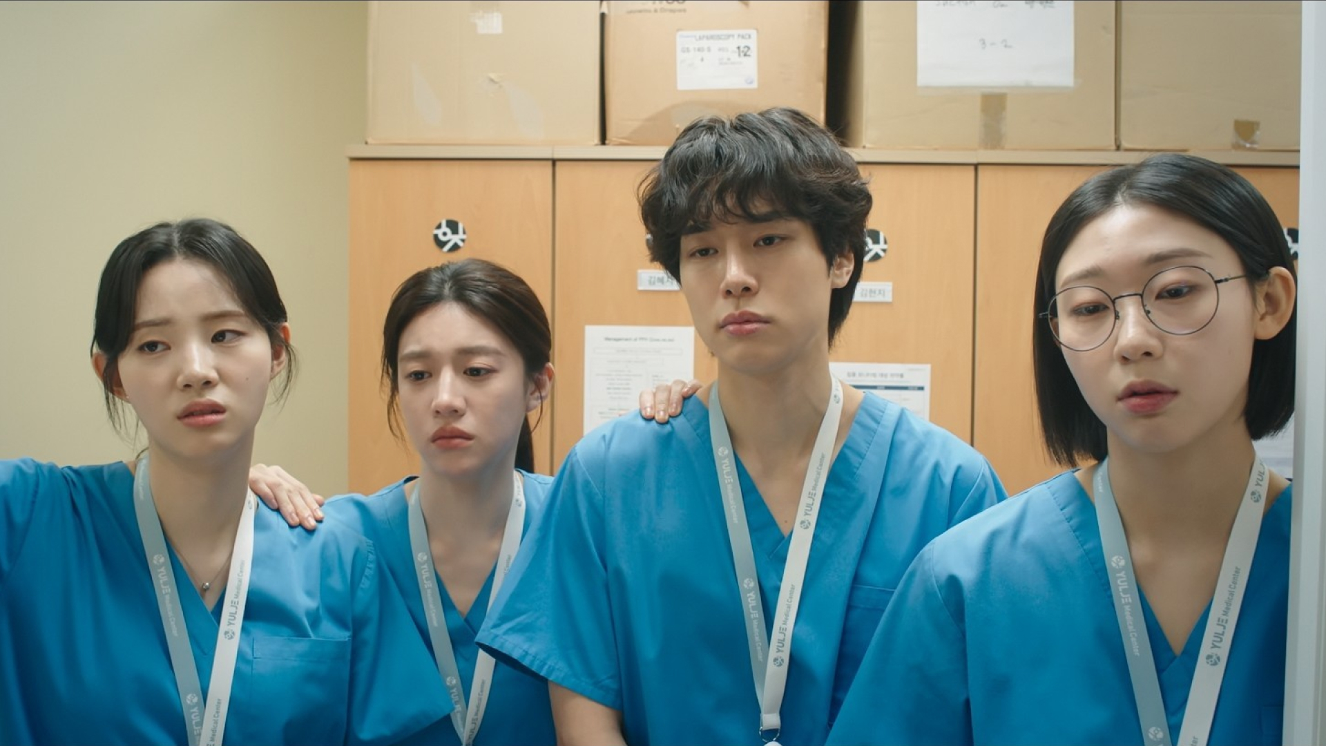 Four young doctors look tired while standing in front of lockers, in 'Resident Playbook.'