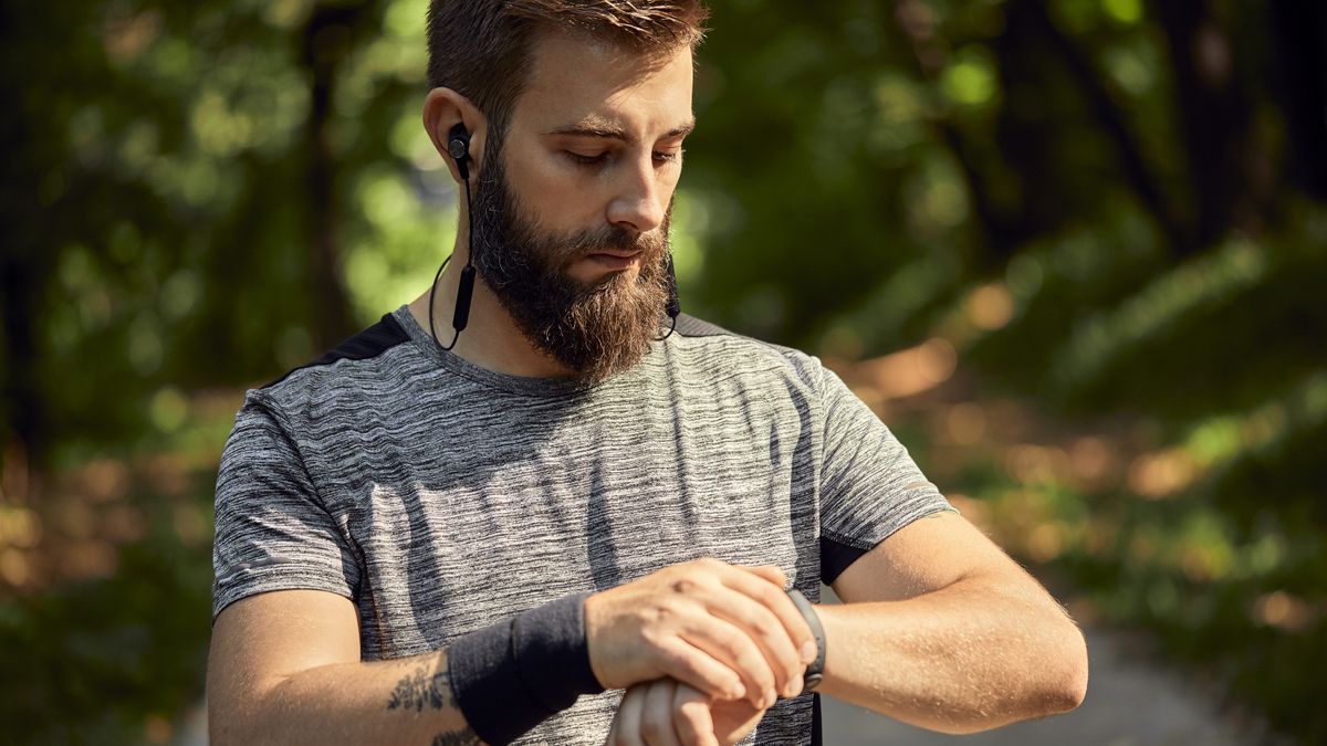 Bearded man using GPS watch