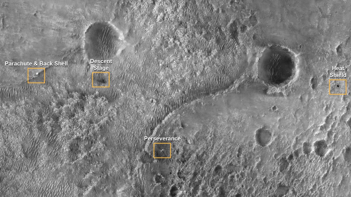 This first image of NASA&rsquo;s Perseverance Rover on the surface of Mars from the High Resolution Imaging Experiment (HiRISE) camera aboard NASA&rsquo;s Mars Reconnaissance Orbiter (MRO) shows the many parts of the Mars 2020 mission landing system that got the rover safely on the ground. The image was taken on Feb. 19, 2021. An annotated version of the image points out the locations of the parachute and back shell, the descent stage, the Perseverance rover, and the heat shield. Each inset shows an area about 650 feet (200 meters) across.