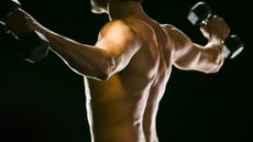 Caucasian man exercising with dumbbells