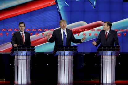 Donald Trump, center, speaks as Sen. Marco Rubio, R-Fla., left, and Sen. Ted Cruz, R-Texas, right, at a Republican presidential debate, Feb 25, 2016. 