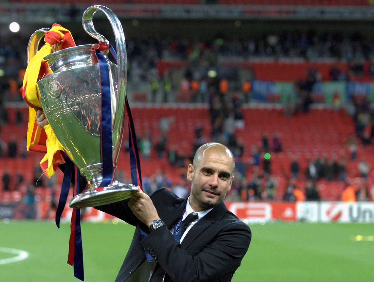 Barcelona manager Pep Guardiola holds the Champions League trophy following his side's victory over Manchester United in the 2011 final at Wembley