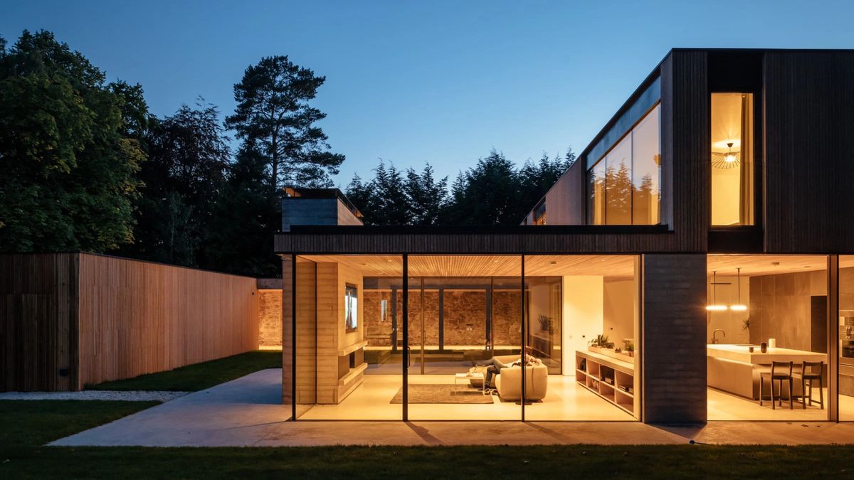 night time shot of exterior of contemporary passivhaus with large glass windows