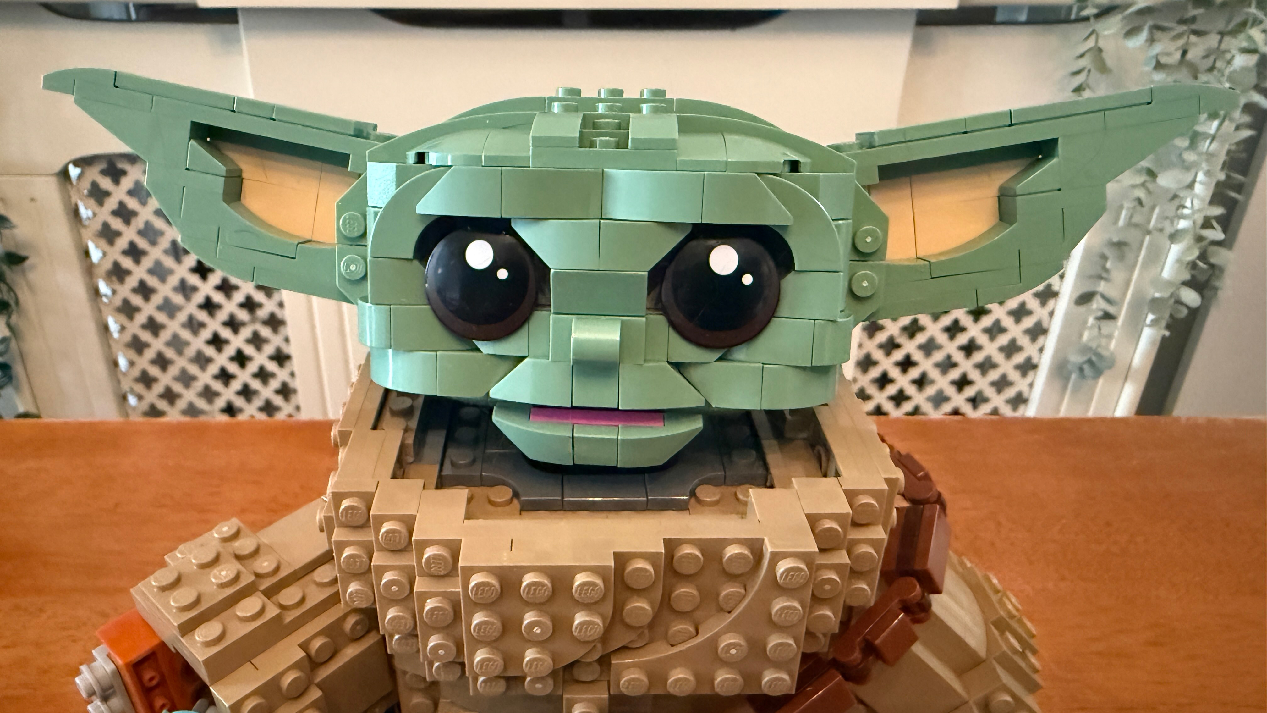 A close up of the face of Lego Grogu (Mandalorian Apprentice) (75446)