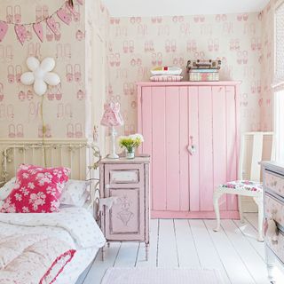 girls bedroom with ballet wallpaper and pink wardrobe