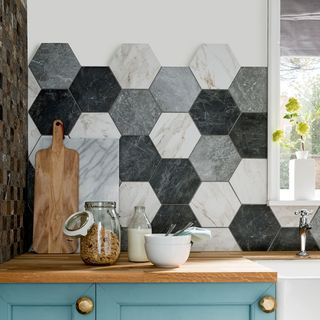 hexagonal designed white and grey tile wall wooden counter and food jar