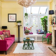 Living room with pink sofa and white window 