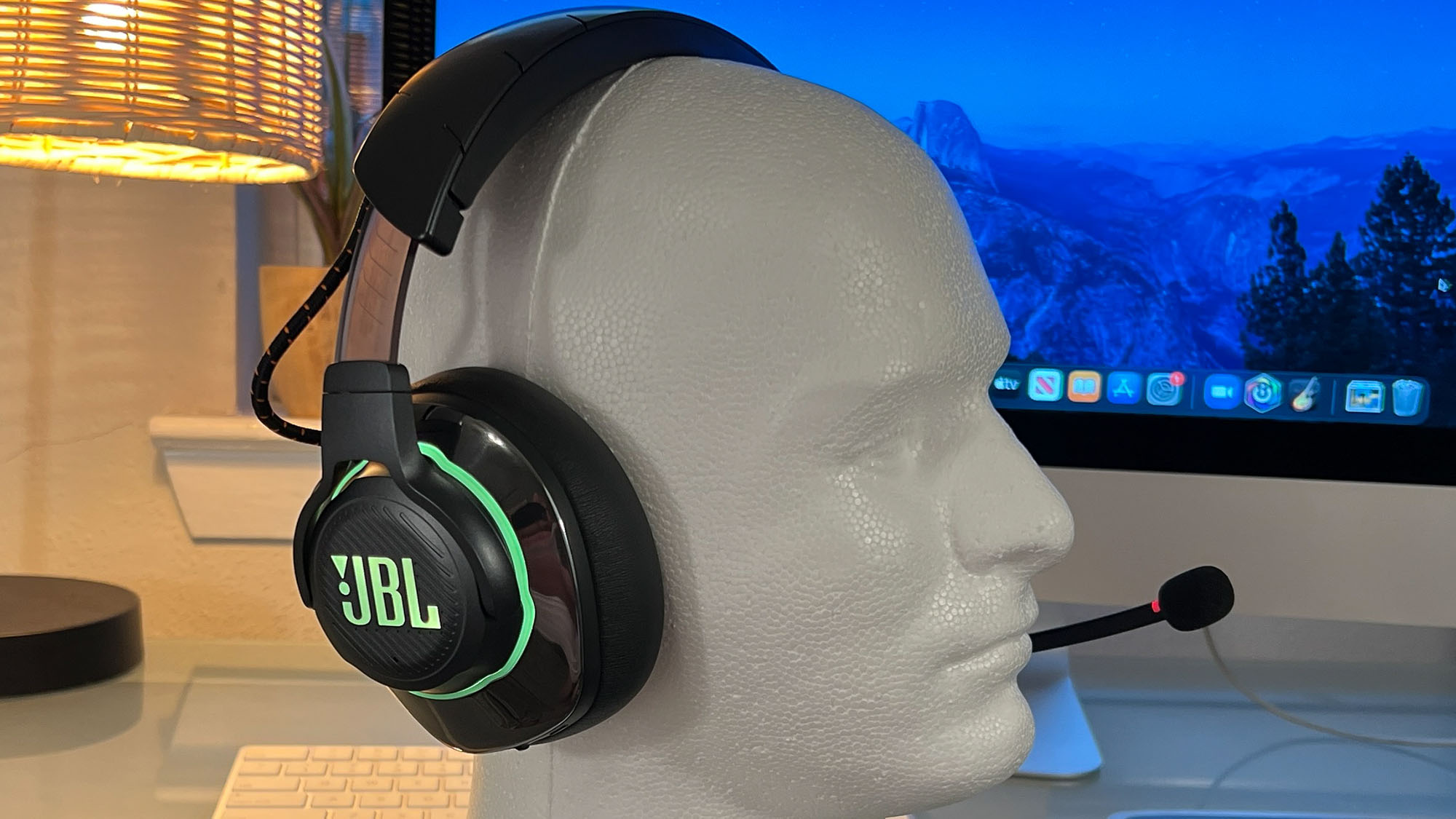 A JBL Quantum 810 Wireless gaming headset on a styrofoam head