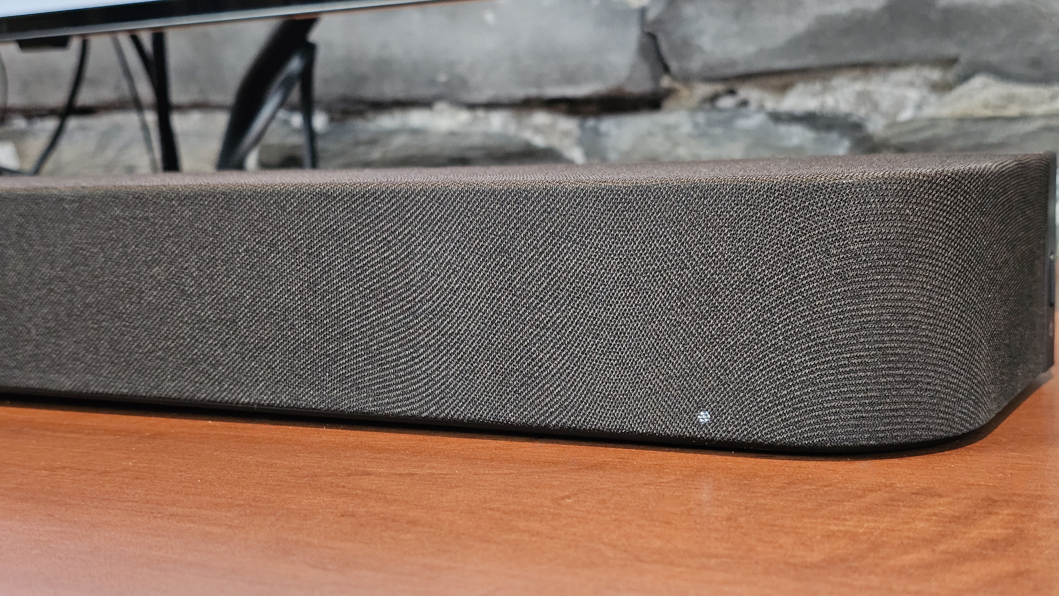 A close up of the Sony Bravia Theater Bar 7 on a wooden surface under a television