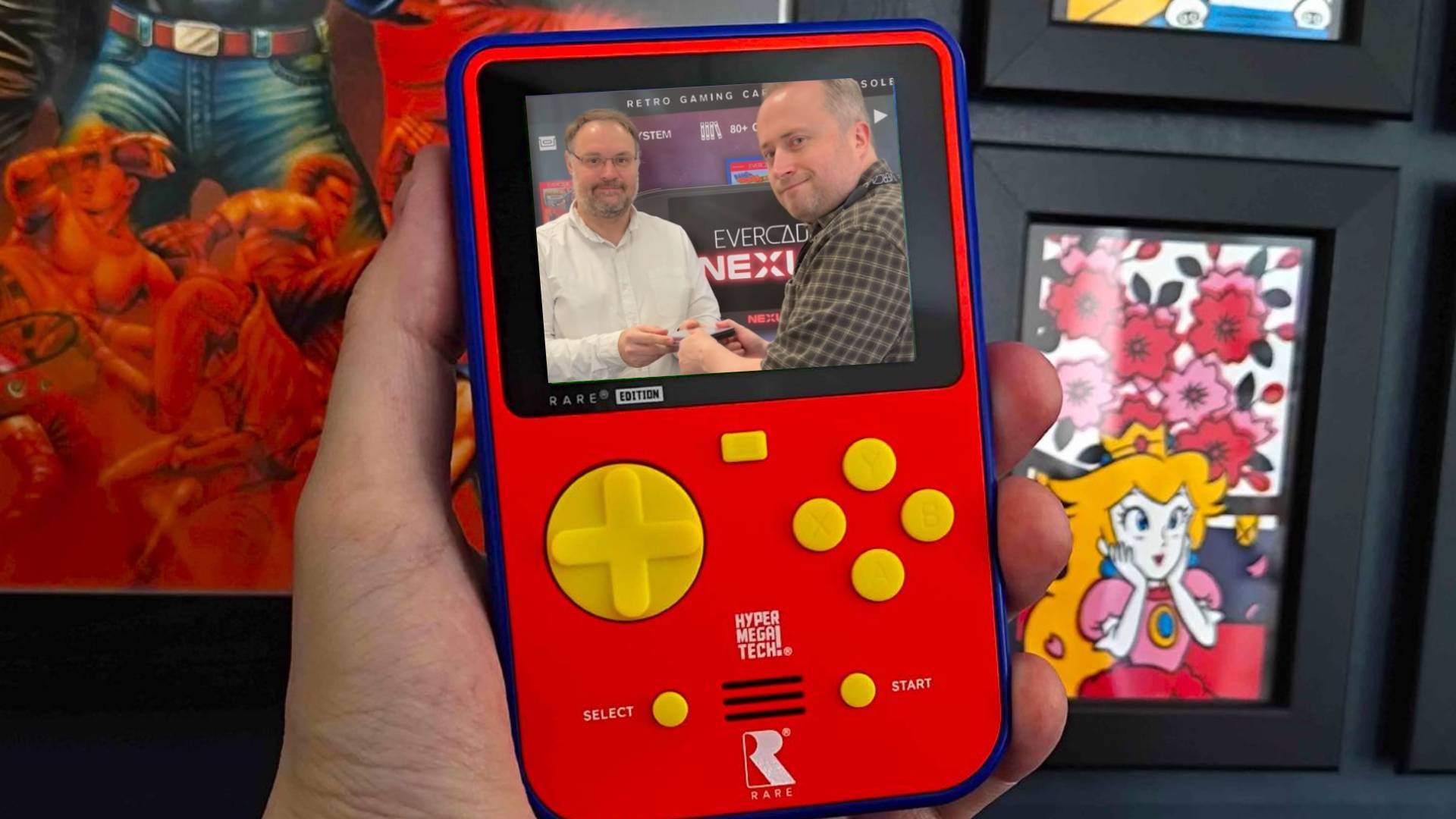 Hand holding Super Pocket Rare Edition with Blaze's Sean Cleaver and Ben Grunbaum on screen.