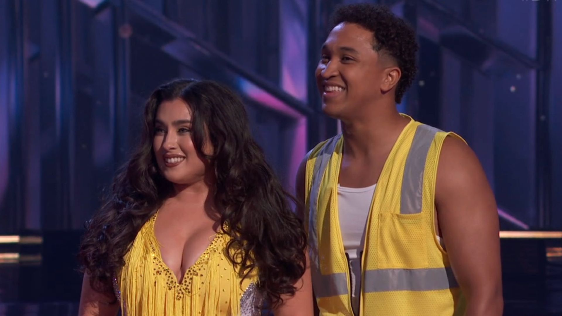 Brandon Armstrong wearing a yellow construction vest and Lauren Jauregui wearing a yellow dress on DWTS.