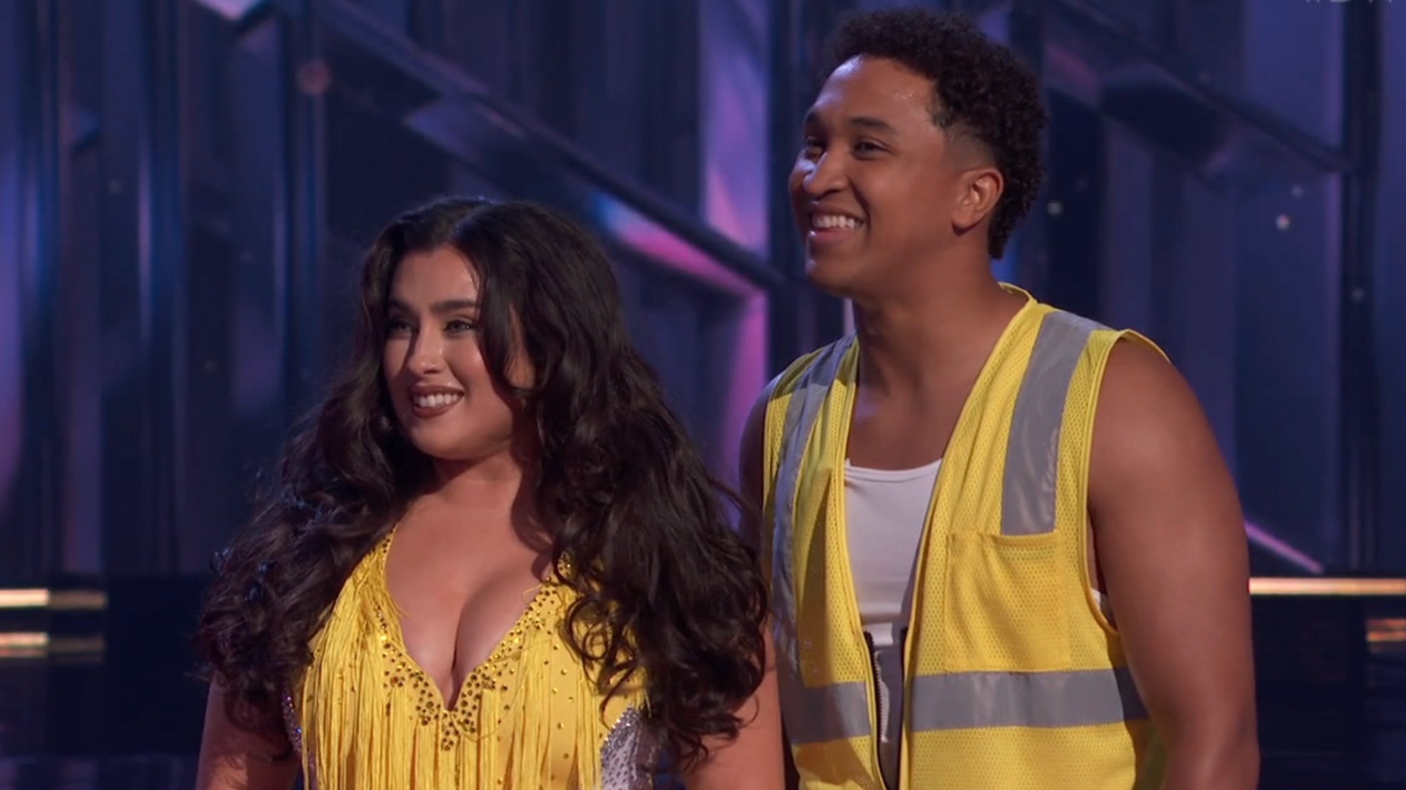 Brandon Armstrong wearing a yellow construction vest and Lauren Jauregui wearing a yellow dress on DWTS.