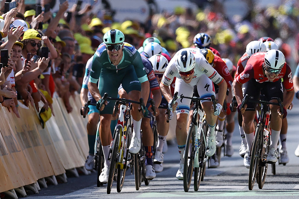 Soudal Quick-Step team's Belgian rider Tim Merlier (C) sprints to the finish line to win ahead of Lidl - Trek team's Italian rider Jonathan Milan wearing the best sprinter's green jersey (L) placing second and Lotto team's Belgian rider Arnaud De Lie placing third (R) during the 9th stage of the 112th edition of the Tour de France cycling race, 174.1 km between Chinon and Chateauroux, central France, on July 13, 2025. (Photo by Anne-Christine POUJOULAT / AFP) (Photo by ANNE-CHRISTINE POUJOULAT/AFP via Getty Images)