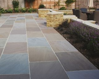 patio laid with different colored stone paving slabs