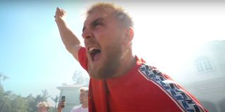 Jake Paul lifting his arm and shouting.