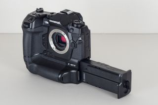 The integrated grip houses the E-M1X' dual battery cartridge