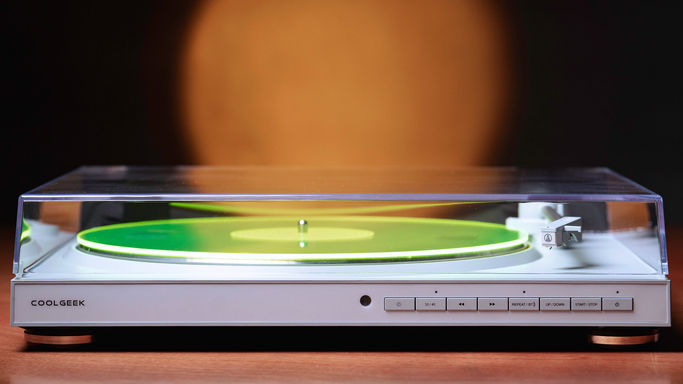 The CoolGeek TS-01 turntable, with its platter glowing green, thanks to RGB lighting