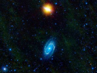 This image from NASA's WISE telescope features the galaxies Messier 81 and Messier 82, which swept by each other a few hundred million years ago, and will likely continue to twirl around each other before eventually merging into a single galaxy.