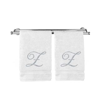 Two white monogramed towels on a towel rail