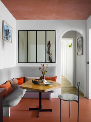 Small dining room with terracotta floor and ceiling
