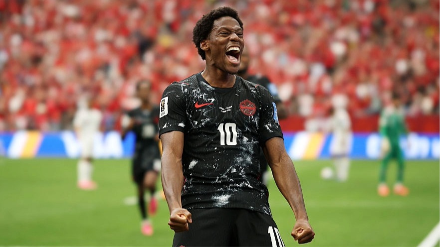 Jonathan David of Canada clenches his fists as he celebrates scoring a goal.