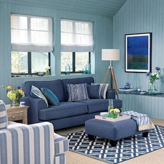 Blue living room with blue sofa and matching ottoman
