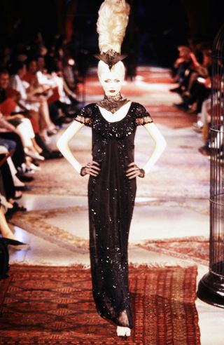 a model on the givenchy runway in 1997 wearing the dress Kaia Gerber would wear to the academy museum gala in 2024