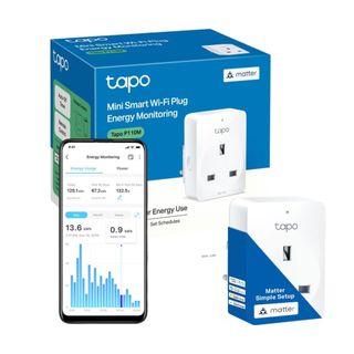 White Tapo smart plug next to its blue box and a smart phone with the app on the screen