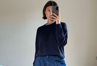 woman in navy sweater and jeans