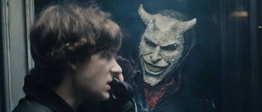 The Grabber standing outside a phone booth Finney is inside in Black Phone 2