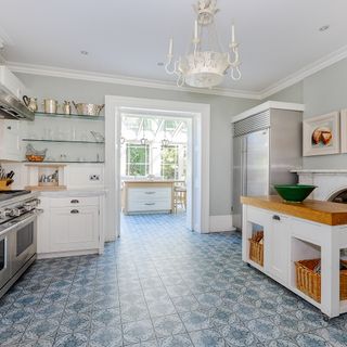 kitchen with tiles flooring and white cabinets