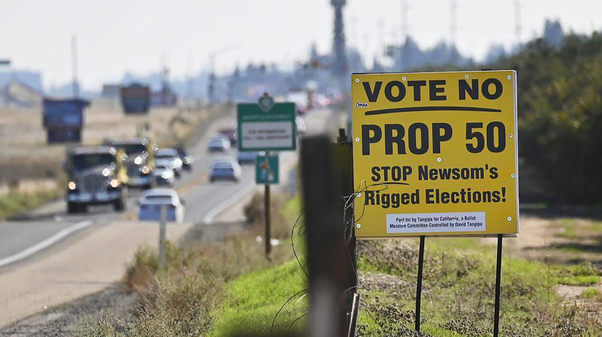 Traffic passes a Vote No On Prop. 50 sign along Highway 41 near Avenue 12 on Oct. 28, 2025, just north of Fresno, California. (Eric Paul Zamora/The Fresno Bee/Tribune News Service via Getty Images)