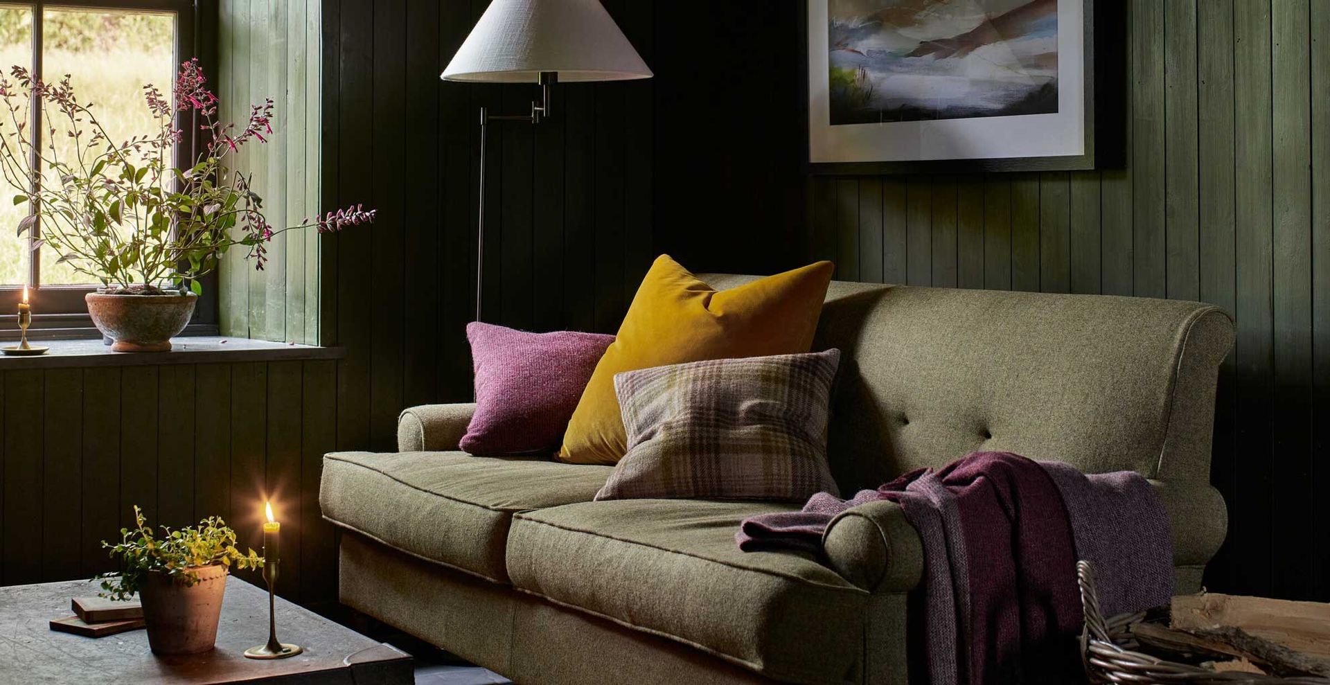 forest green painted living room with sage green sofa to highlight the forest green color trend