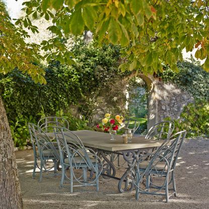 garden with marble topped table and bentwood chairs 