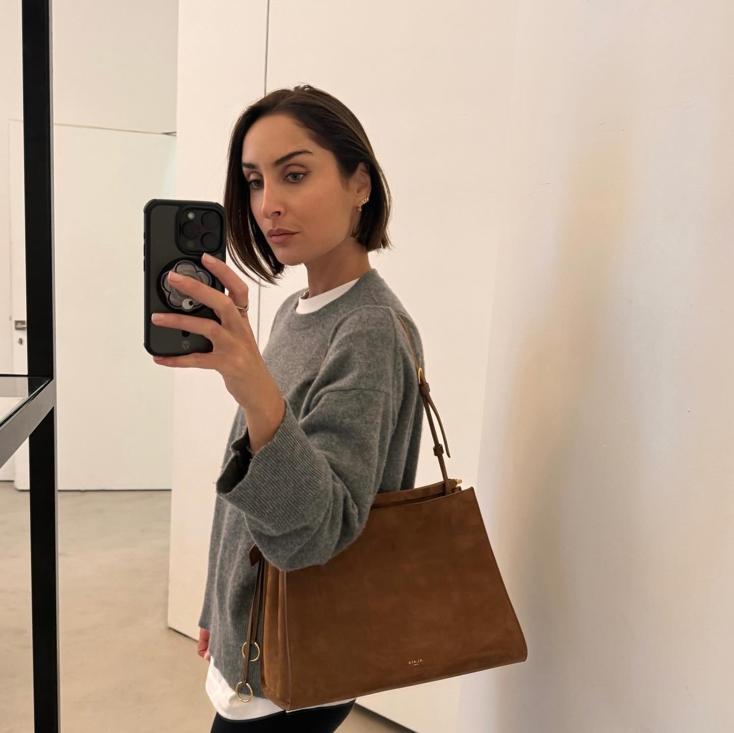 Influencer Erin wears a heather grey cashmere crewneck.
