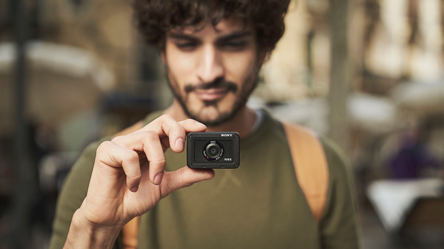 The Sony RX0 II being held between a finger and thumb