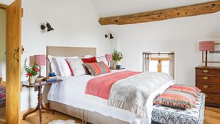 bedroom in barn conversion with exposed beams