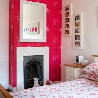 bedroom with white wall and bed and fireplace