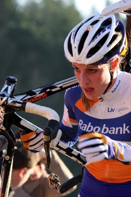 Lucinda Brand carries her bike