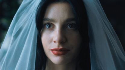 Camile Morrone wears a bridal veil