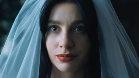 Camile Morrone wears a bridal veil