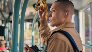Male wearing Sony LinkBuds WF-L900 while riding a bus