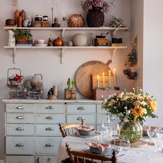 christmas dining table with flowers and vintage sideboard with candles and ephemera
