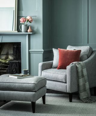 living room with fire place and grey chair